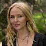 Portrait of Jewel wearing sterling silver arrow head earrings with rainbow moonstones from her Handmade Collection of jewelry Songlines by Jewel