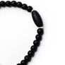 Black jade bead bracelet with sterling silver accents on white backdrop