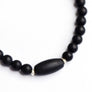 Black jade bead bracelet with sterling silver accents on white backdrop