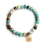 Blue jasper bead stretch bracelet with gold filigree star charm accented with a set polki diamond.