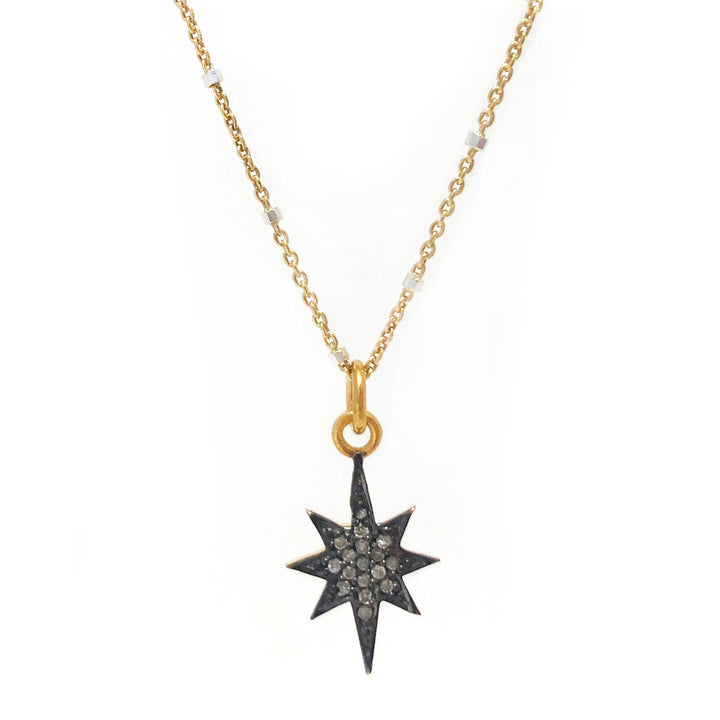 Diamond 8 pointed star charm on gold vermeil chain.