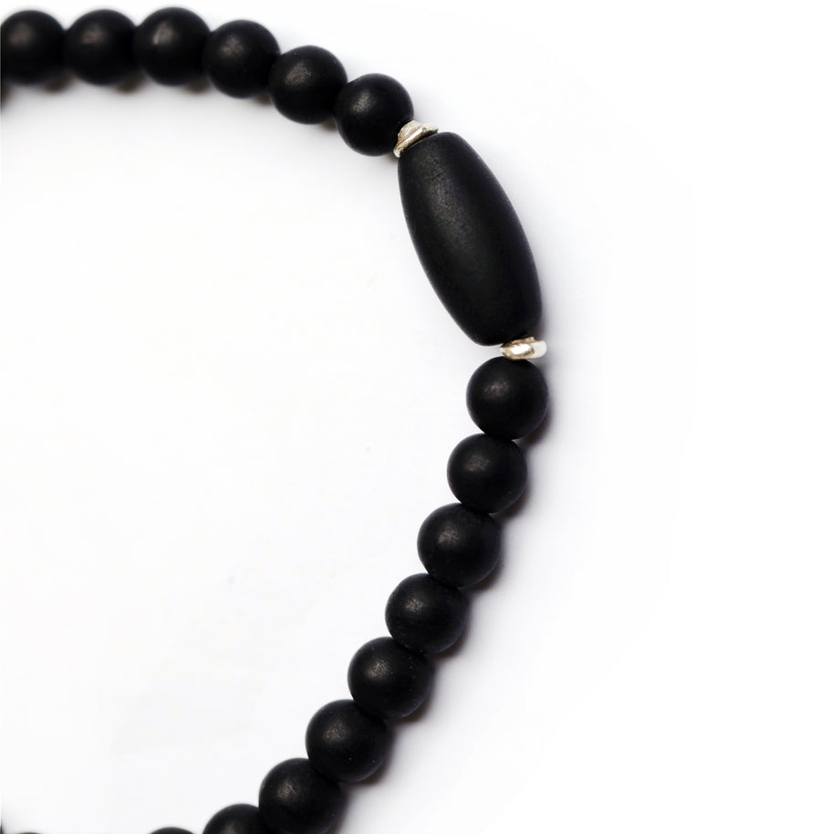 Black jade bead bracelet with sterling silver accents on white backdrop