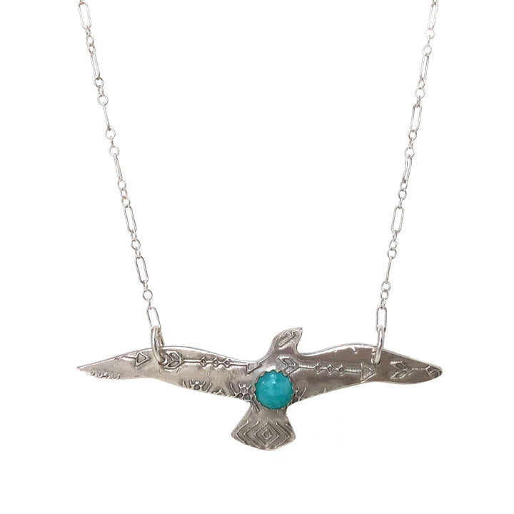 Flying bird pendant w/ amazonite cabochon on a sterling silver chain on white background 