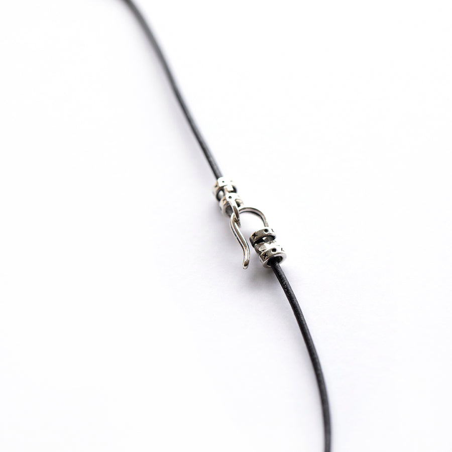 Silver clasp on leather cord